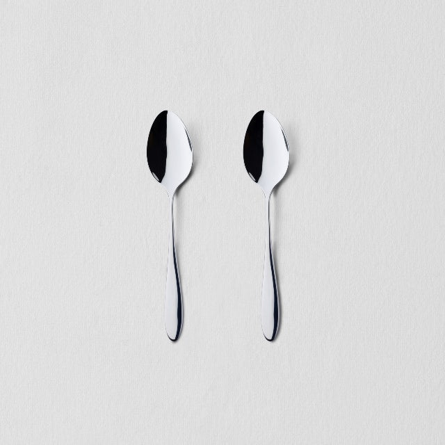 Overhead view of two classic stainless steel breakfast spoons