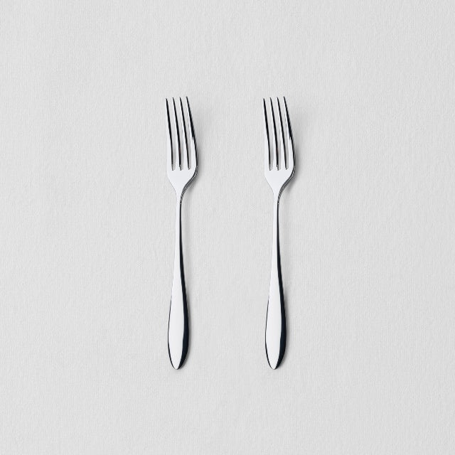Overhead view of two classic stainless steel dinner forks
