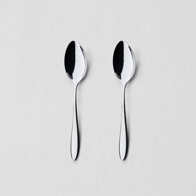 Overhead view of two classic stainless steel dinner spoons