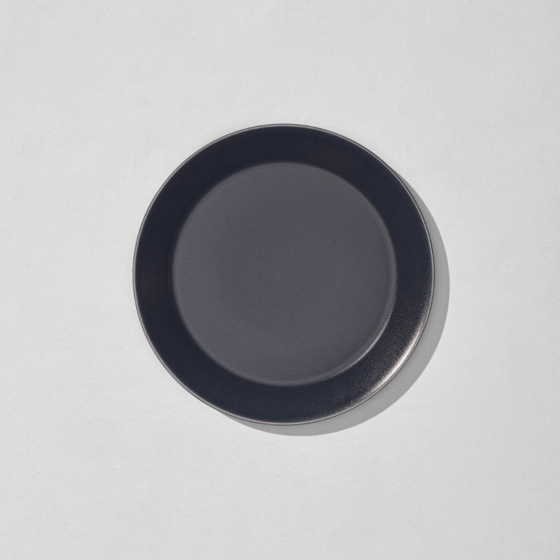 Overhead view of charcoal navy dinner plate