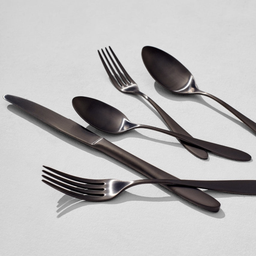Angled view of satin black flatware pieces