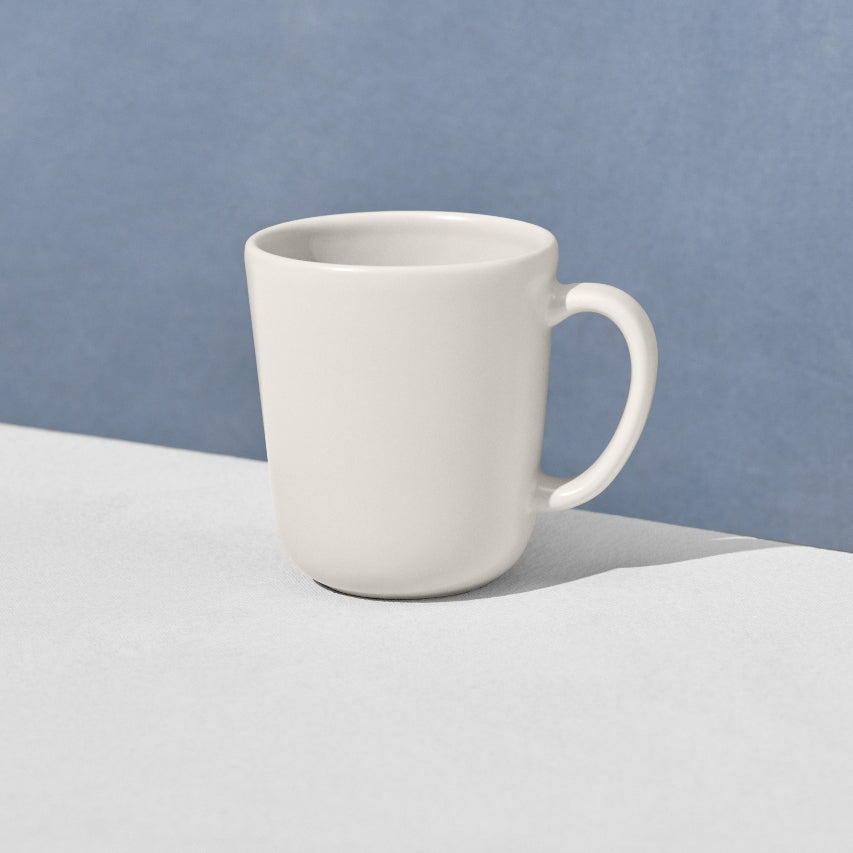 Angled view of single off white mug