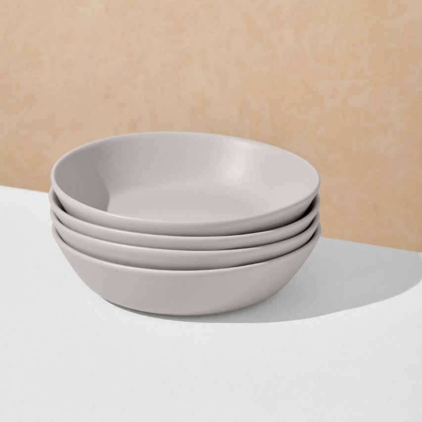 Stack of four grey pasta bowls