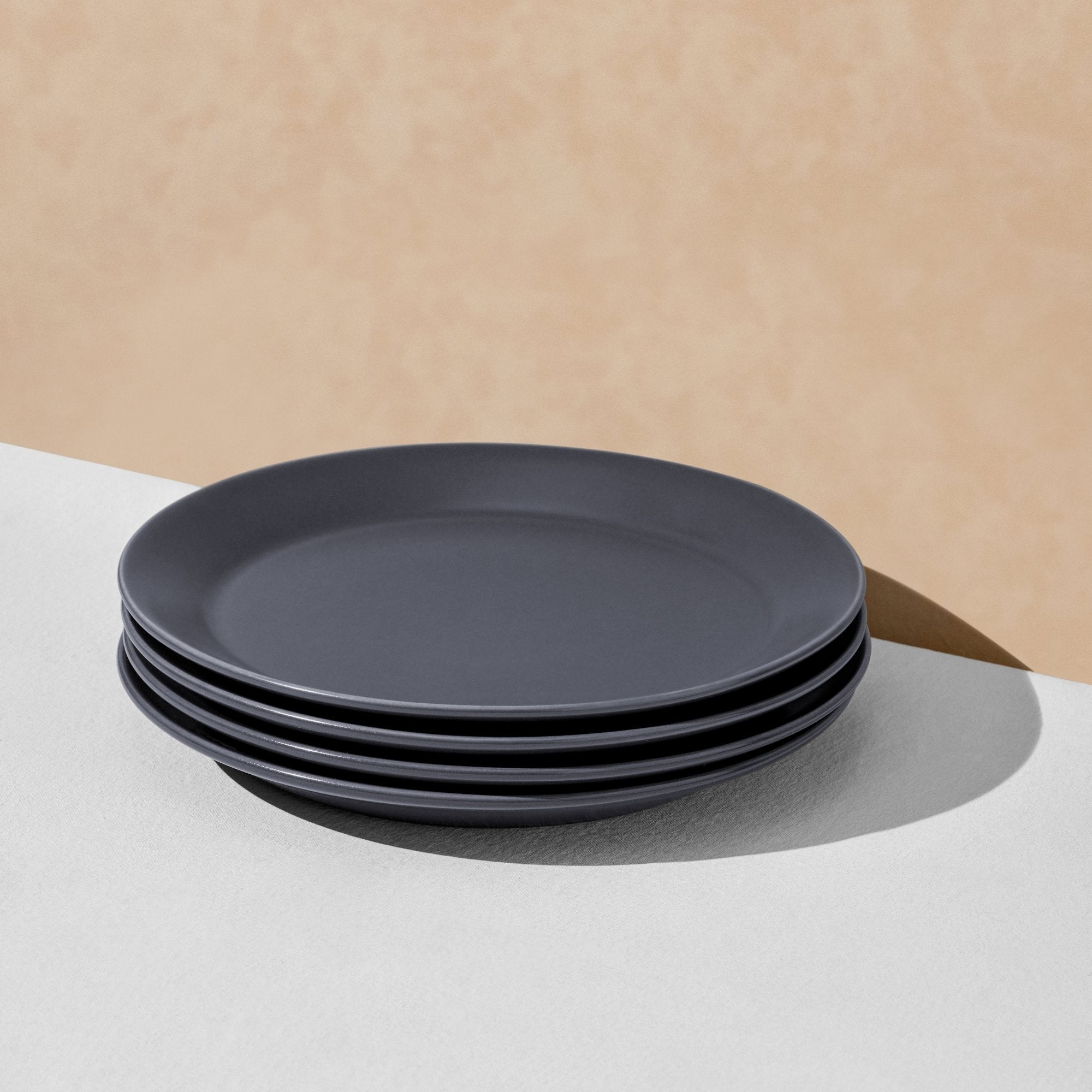 Stack of four charcoal navy dinner plates