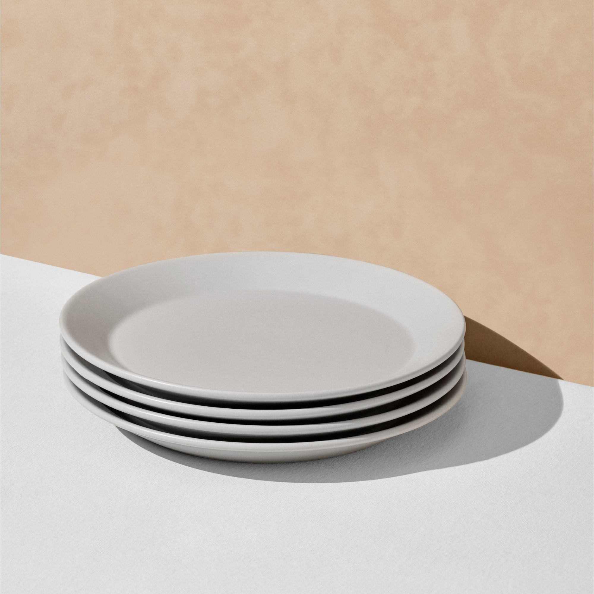 Stack of four grey dinner plates