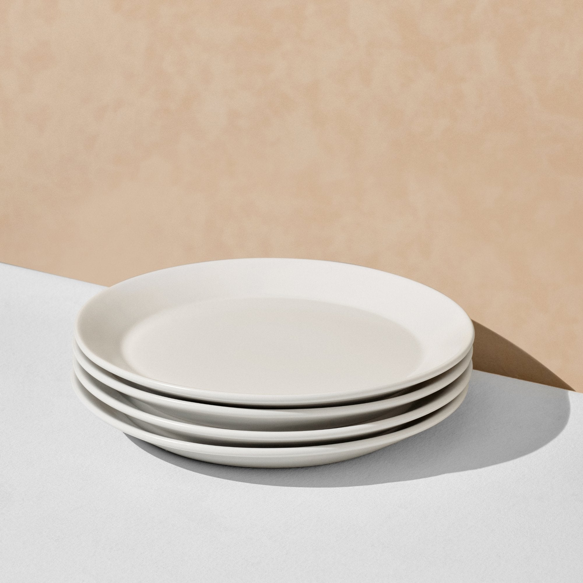 Stack of four off white dinner plates
