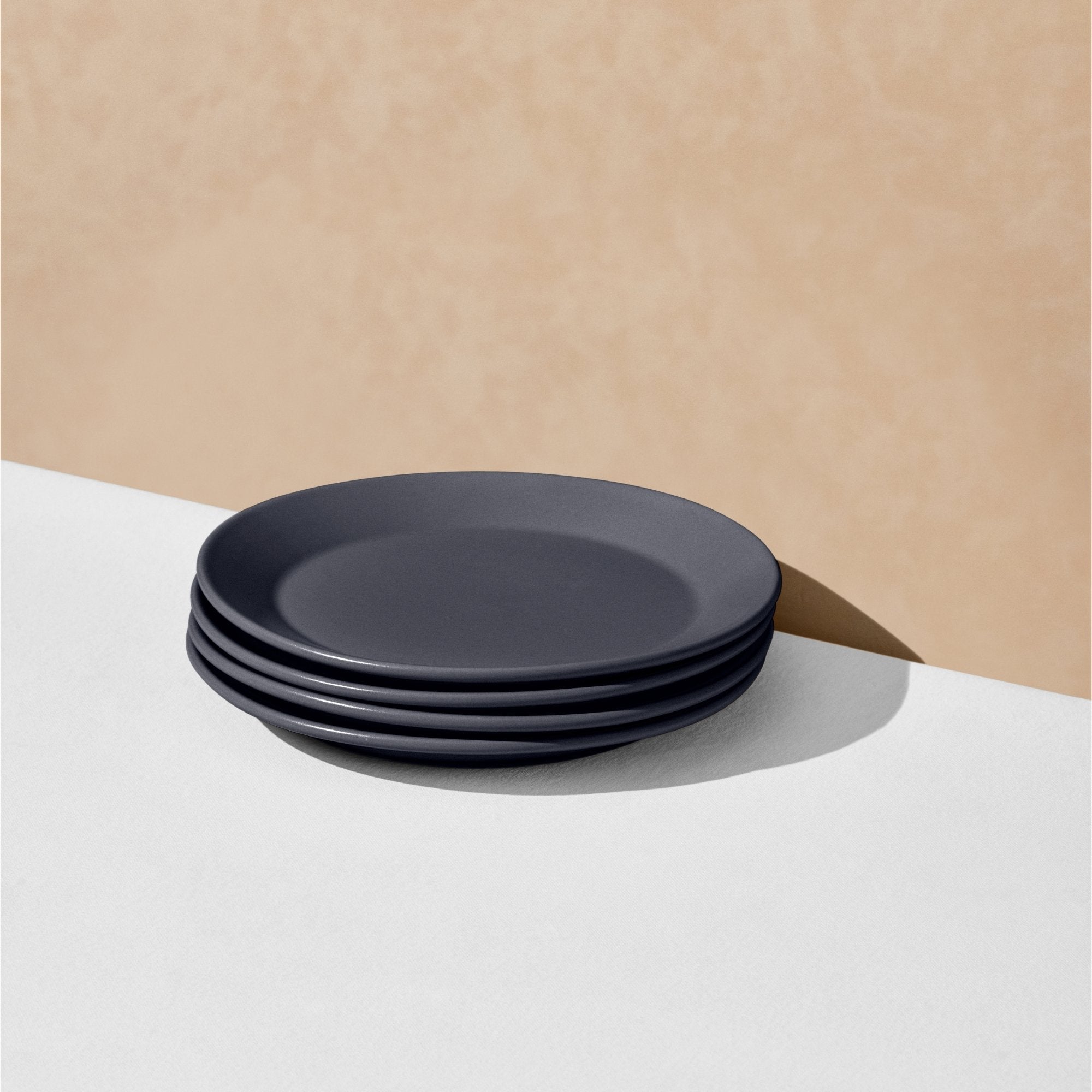 Stack of four charcoal navy salad plates