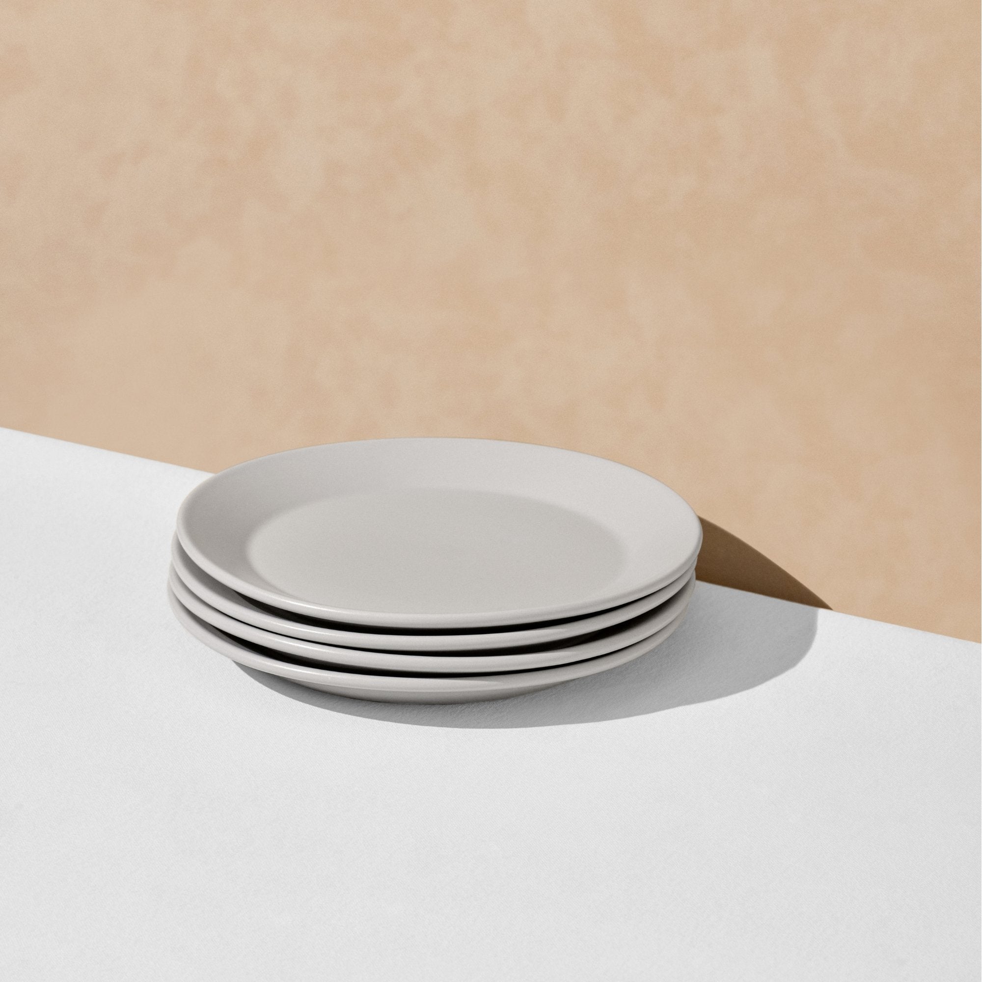 Stack of four grey salad plates